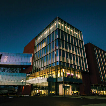 Des Moines University’s Edge of Advancement building at dusk.