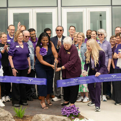 Des Moines University president and CEO Angela L. Walker Franklin, Ph.D., along with other DMU leaders and trustees, cuts the ceremonial purple ribbon at the university’s new campus in West Des Moines.