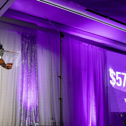 Des Moines University President and CEO Angela L. Walker Franklin, Ph.D., stands on stage and reveals the amount raised for DMU's Purple & Proud Campaign — an astounding $57.1 million.